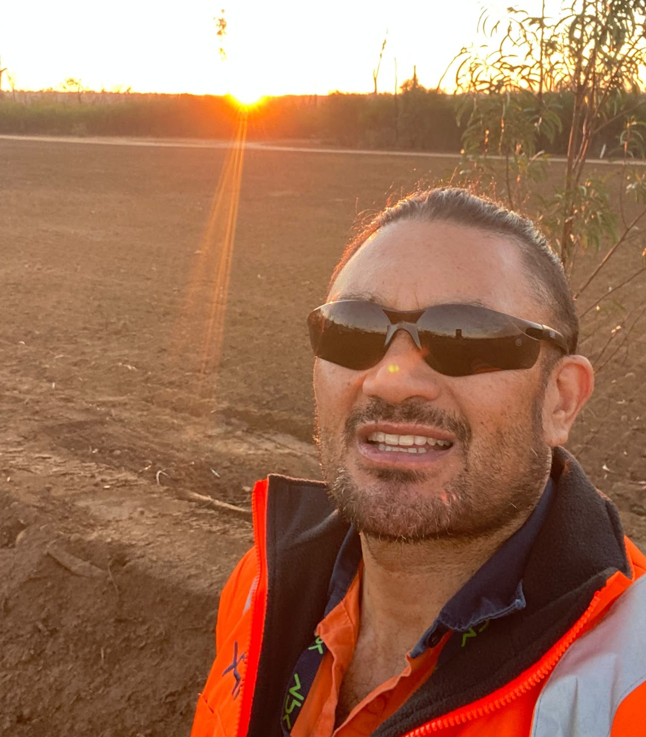 Lucas Heta, Director and Lead Operator of Hetaz Contractorz, on site at sunset
